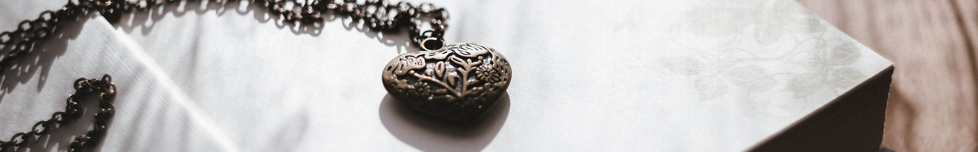 Heart pendant on an open book.